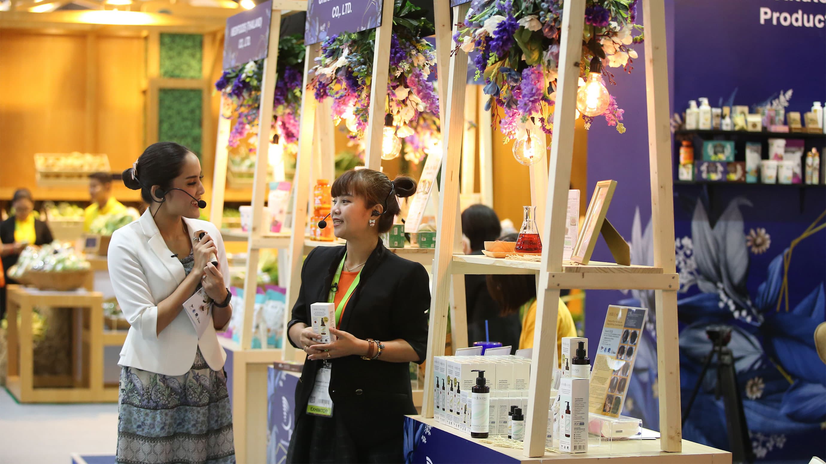 Two women talking about products with headsets